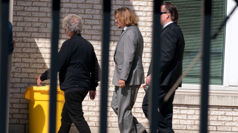 Actor Johnny Depp, center left, leaves the Fairfax County courthouse after a jury selection day in Fairfax Va.