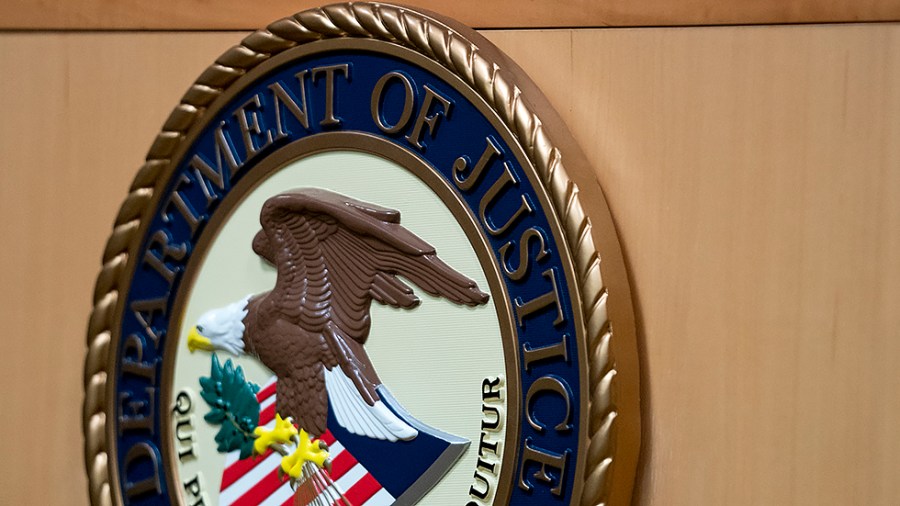 A logo of the Department of Justice is seen on a podium in Washington, D.C., on Friday, April 1, 2022.