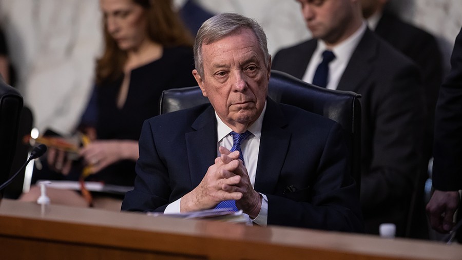 Charman Richard Durbin (D-Ill.) acknowledges Sen. Chris Coons (D-Del.) to initiate his designated time for questioning Supreme Court nominee Judge Ketanji Brown Jackson during the Senate Judiciary Committee confirmation hearing on Wednesday, March 23, 2022.