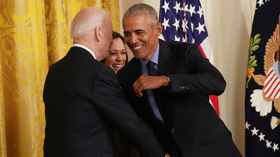 Former President Barack Obama shakes hands with President Joe Biden as they join Vice President Kamala Harris in delivering remarks on the Affordable Care Act and lowering health care costs for families, during a ceremony at the White House in Washington, D.C., on Tuesday, April 5, 2022.