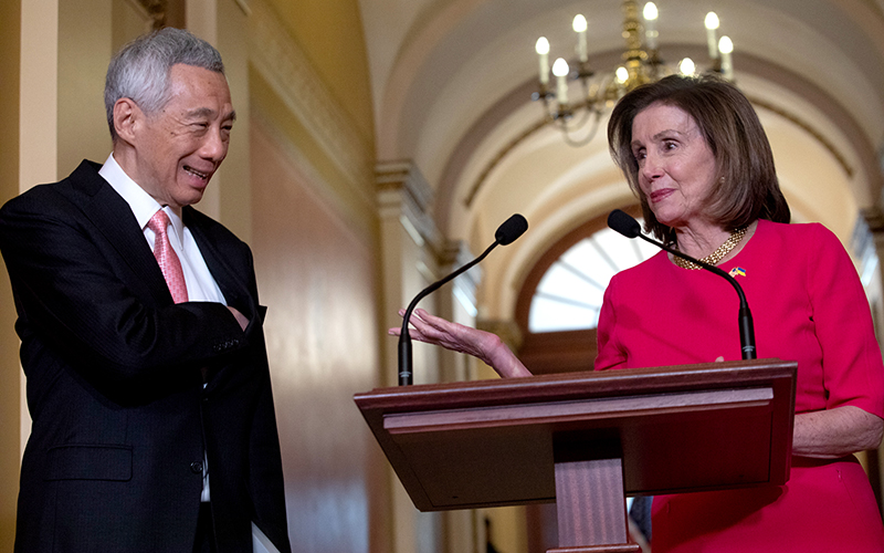 Lee Hsien Loong, left, with Nancy Pelosi at a podium, right