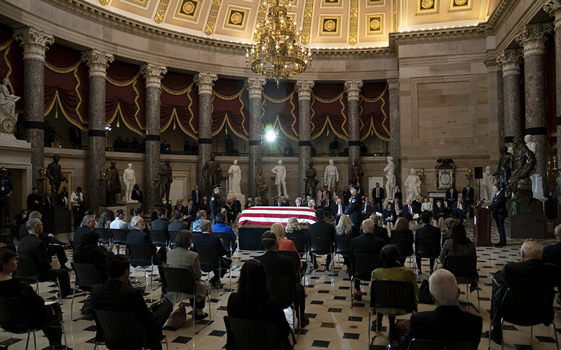 Sen. Dan Sullivan, center of room