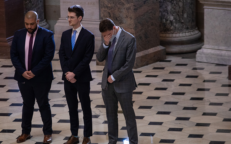 Congressional staffers pay their respects to former Sen. Don Young as one buries his head in his hands