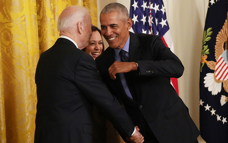 Former President Obama shakes hands with President Biden