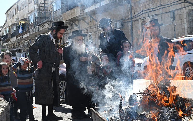 Ultra-Orthodox Jews pray and burn leavened products