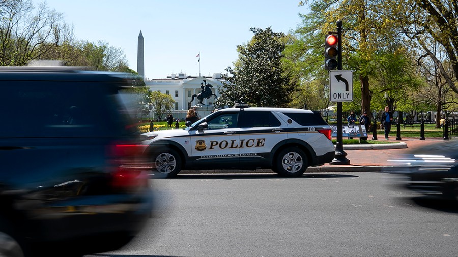 A Secret Service Police officer sits in a cruiser outside Lafayette Square in Washington, D.C., on Wednesday, April 20, 2022.