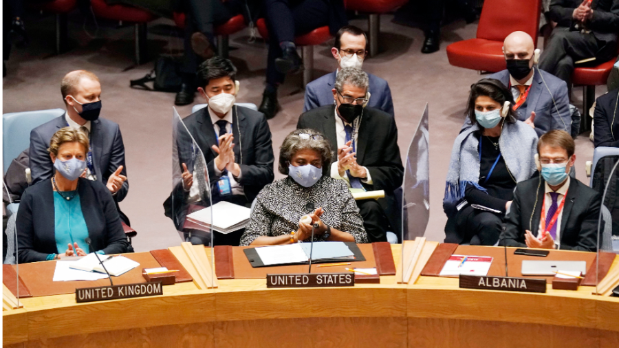 Members of teh United Nations from the United Kingdom, United States and Albania sit side by side.