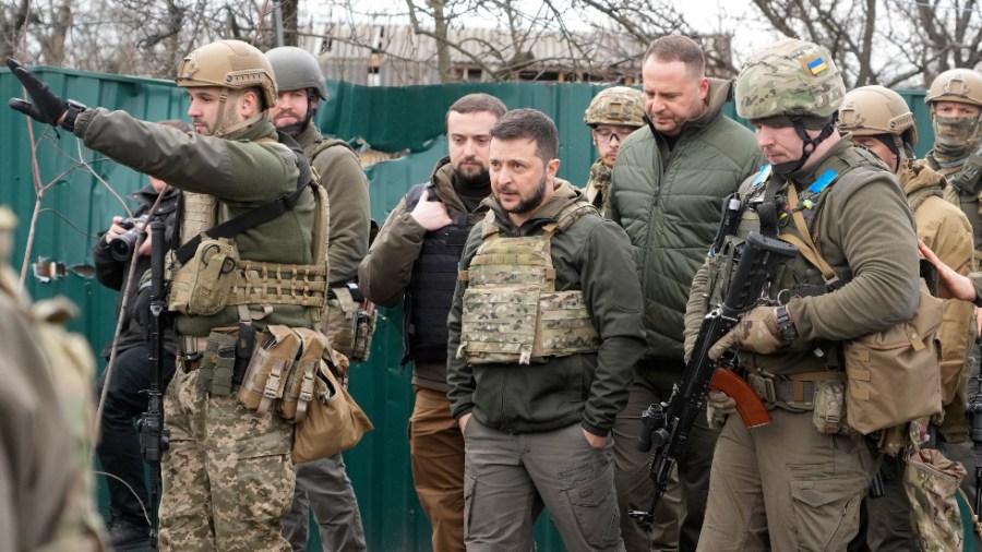 Ukrainian President Volodymyr Zelenskyy examines the site of a recent battle in Bucha close to Kyiv