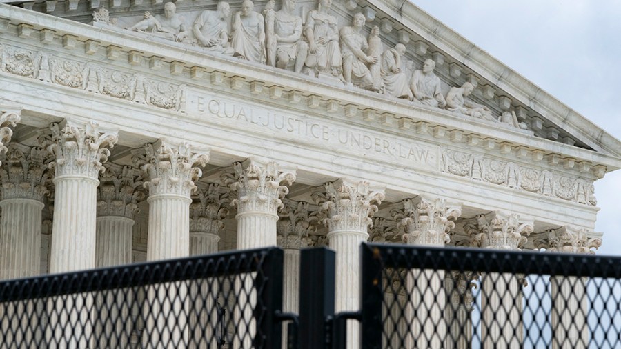 An anti-scaling fence surrounds the U.S. Supreme Court