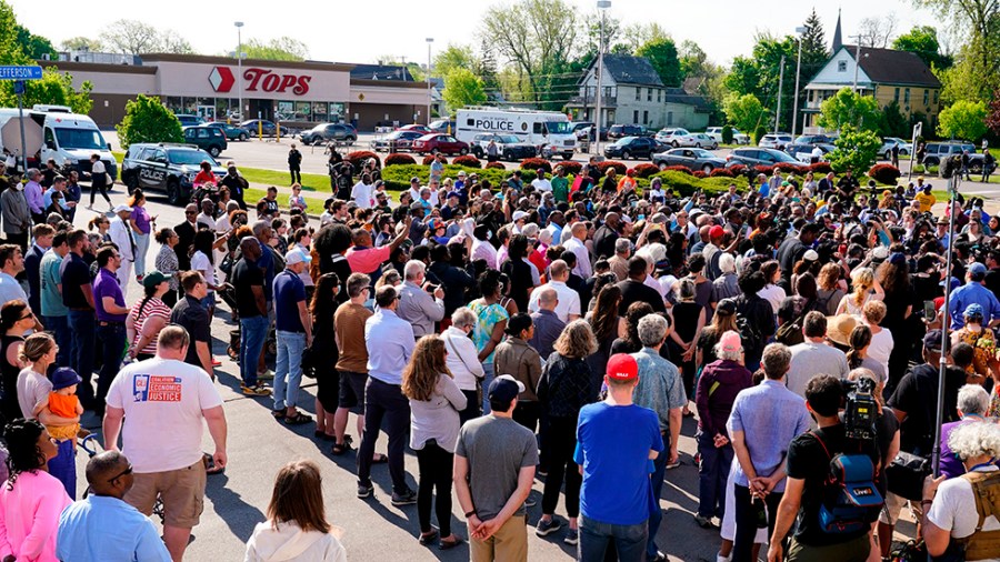 People gather outside a supermarket