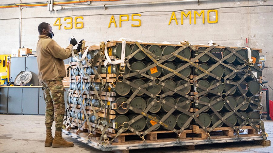 Airmen and civilians from the 436th Aerial Port Squadron palletize ammunition