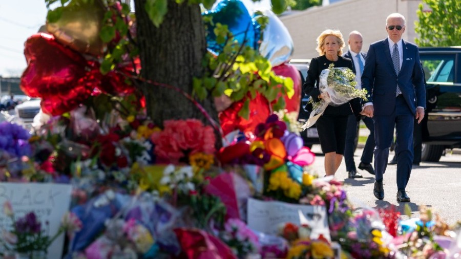 President Joe Biden and first lady Jill Biden pay their respects to the victims of Saturday's shooting at a memorial across the street from the TOPS Market in Buffalo, N.Y.