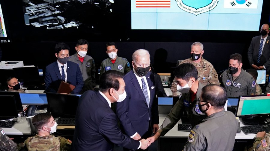 U.S. President Joe Biden, center, and South Korean President Yoon Suk Yeol, center left, greet the members of the Combat Operations Floor at the Osan Air Base