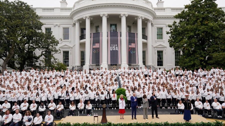 On stage from left, first lady Jill Biden, President Joe Biden, Vice President Kamala Harris and second gentleman Doug Emhoff stand for the national anthem during an event with athletes from the Tokyo 2020 Summer Olympic and Paralympic Games, and Beijing 2022 Winter Olympic and Paralympic Games