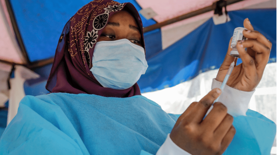 A nurse prepares to administer an AstraZeneca vaccination against COVID-19, in the low-income Kibera neighborhood of Nairobi, Kenya.