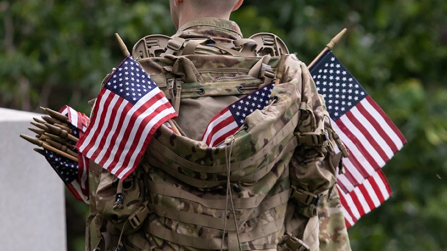 Flags are placed in front of more than 280,000 headstones of U.S. military personnel buried at Arlington National Cemetery, in preparation for Memorial Day, in Arlington, Va., on Thursday, May 26, 2022.