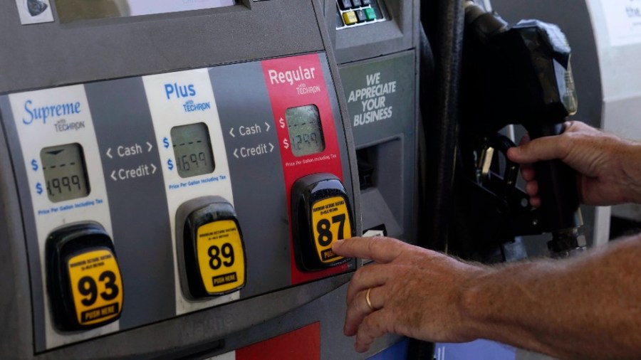 A customer pumps gas at an Exxon gas station, Tuesday, May 10, 2022, in Miami.