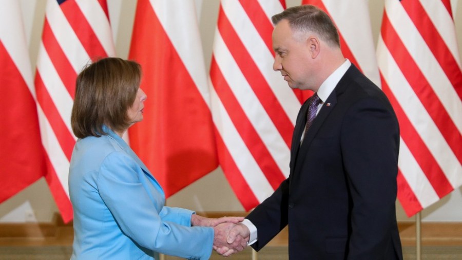 In this photo released by the Office of the President of Poland, Speaker Nancy Pelosi and Poland's President Andrzej Duda shake hands in Warsaw