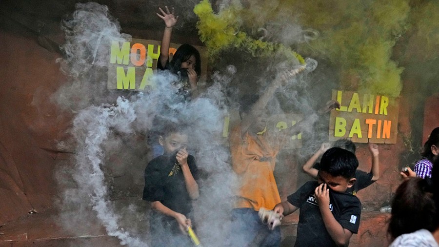 Young boys light smoke bombs