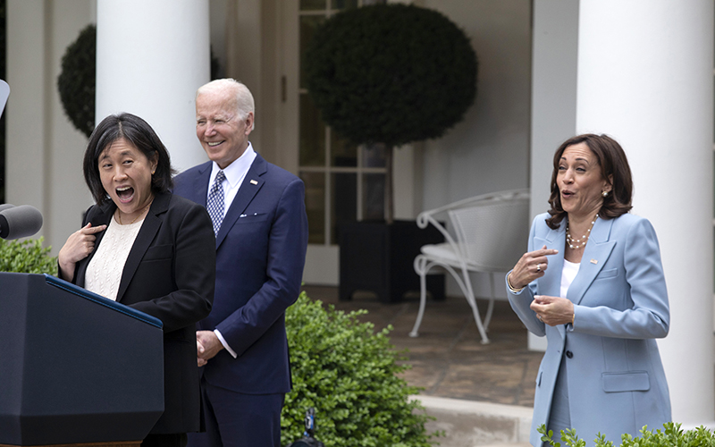 U.S. Trade Representative Katherine Tai and Vice President Harris laugh as President Biden smiles in the background