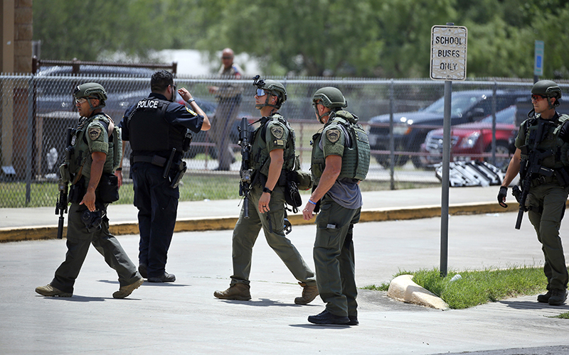 Law enforcement personnel stand outside Robb Elementary