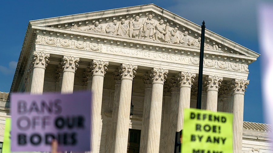 Protesters are seen outside the Supreme Court on Tuesday, May 3, 2022 after the leak of a draft majority opinion written by Justice Samuel Alito preparing for the court to overturn Roe v. Wade later this year.