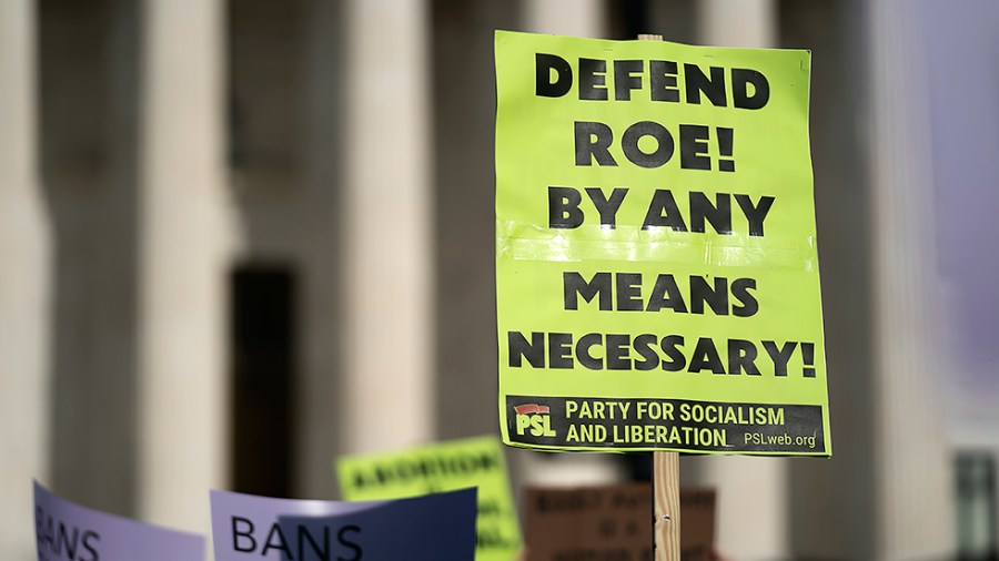 Protesters are seen outside the Supreme Court on Tuesday, May 3, 2022 after the leak of a draft majority opinion written by Justice Samuel Alito preparing for the court to overturn Roe v. Wade later this year.