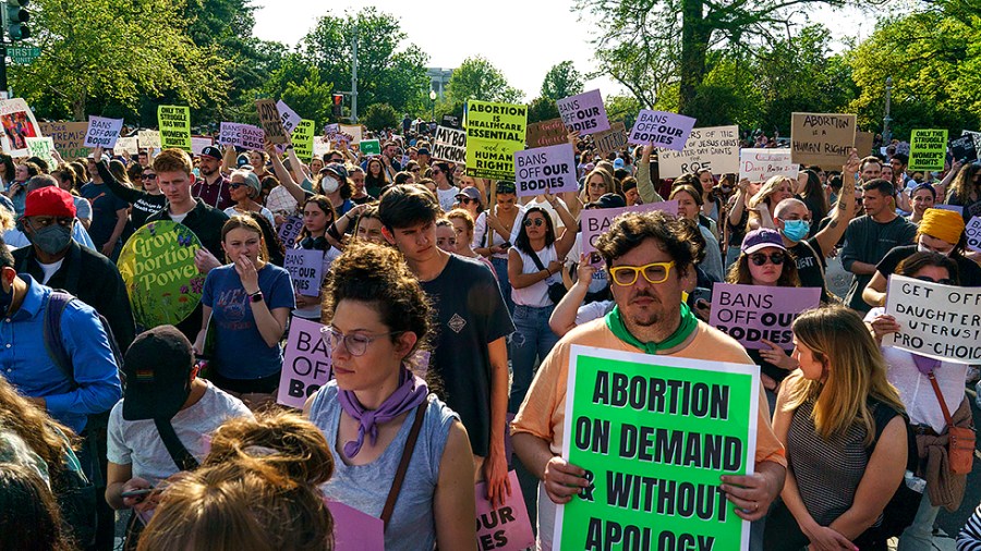 Protesters are seen outside the Supreme Court on Tuesday, May 3, 2022 after the leak of a draft majority opinion written by Justice Samuel Alito preparing for the court to overturn Roe v. Wade later this year.