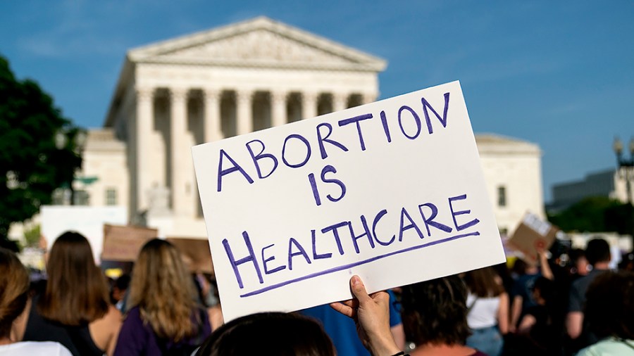 Protesters are seen outside the Supreme Court on Tuesday, May 3, 2022 after the leak of a draft majority opinion written by Justice Samuel Alito preparing for the court to overturn Roe v. Wade later this year.