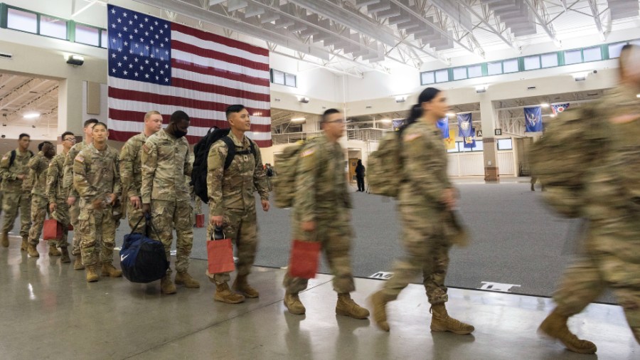 Soldiers with the U.S. Army's 87th Division Sustainment Support Battalion, 3rd Division Sustainment Brigade, wait to board a chartered plane to Europe.