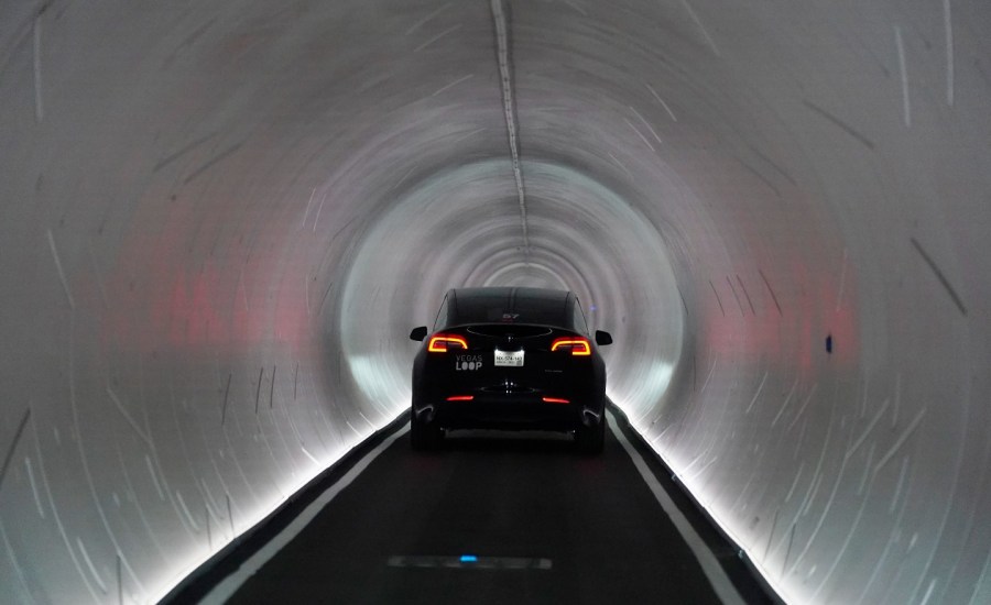 A Tesla drives through a tunnel.