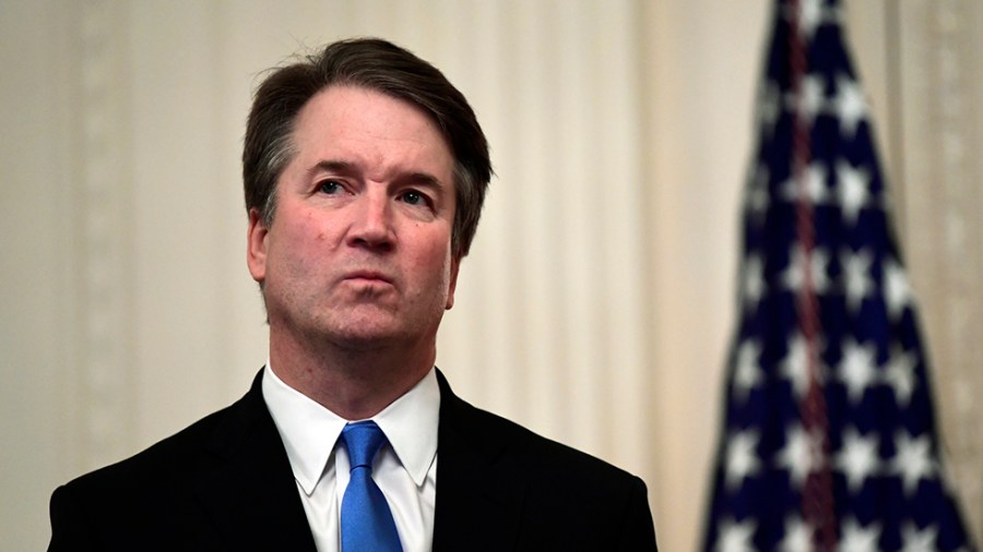 Supreme Court Justice Brett Kavanaugh stands before a ceremonial swearing-in