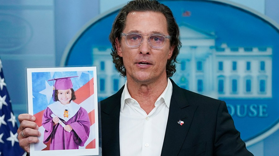 Actor Matthew McConaughey holds a picture or Alithia Ramirez, who was killed in an elementary school shooting