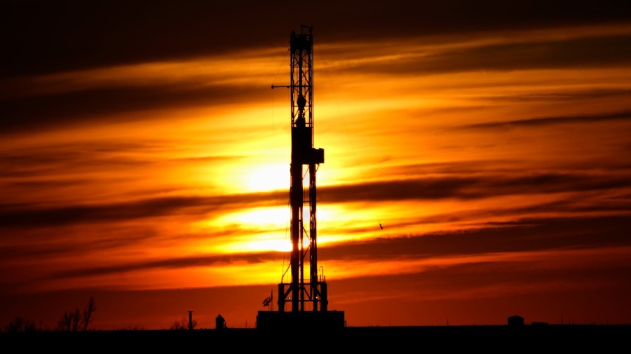 An oil drilling rig is pictured at sunset, Monday, March 7, 2022, in El Reno, Okla.