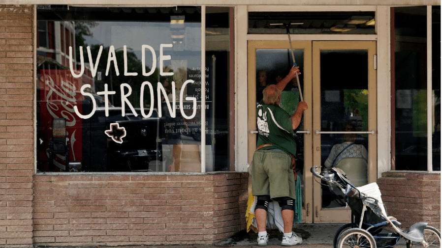 A window washer works around the town square, Thursday, June 9, 2022, in Uvalde, Texas.