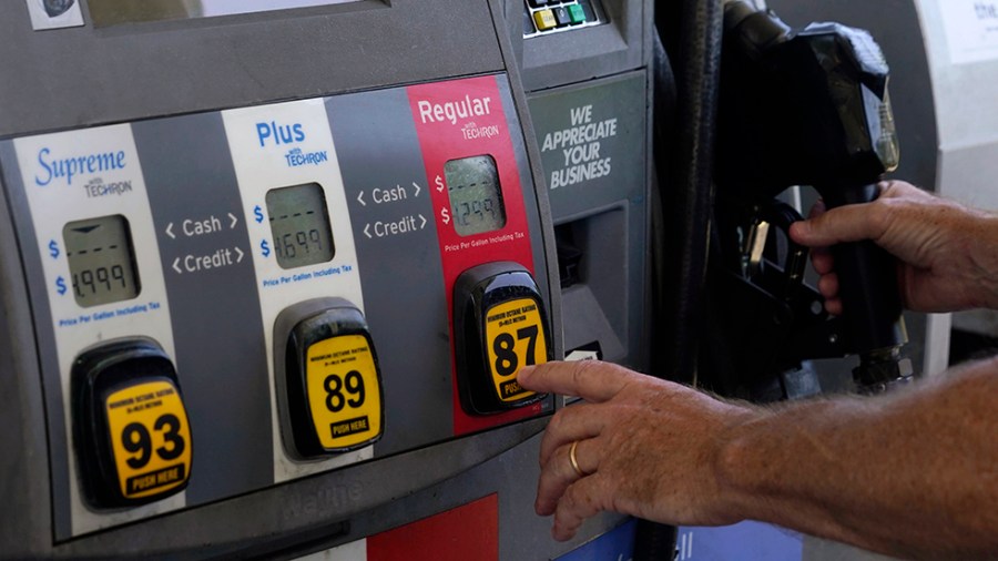 A customer pumps gas at an Exxon gas station