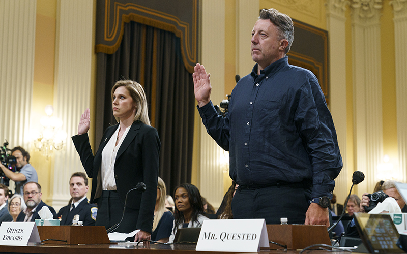 U.S. Capitol Police Officer Caroline Edwards and British filmmaker Nick Quested are sworn in as members of the press take photos