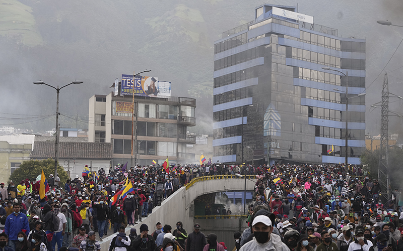 A crowd of demonstrators flood the streets waving flags in protest against the government of Ecuadorian President Guillermo Lasso and rising fuel prices