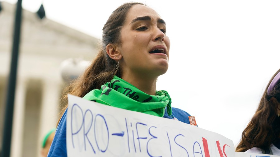 A protester for abortion rights demonstrates outside the Supreme Court on Friday, June 24, 2022 in anticipation of an opinion that could strike Roe v. Wade.