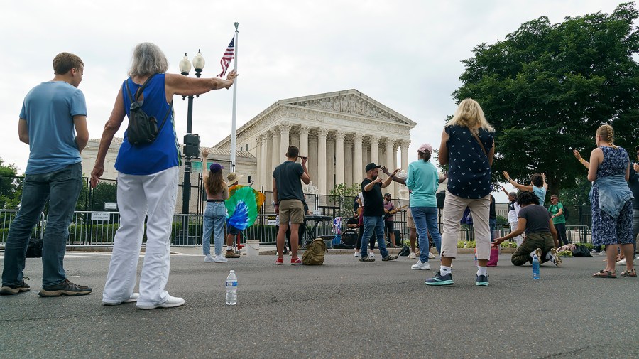 People against abortion listen to Sean Feucht, founder of Let Us Worship, outside the Supreme Court on Monday, June 27, 2022.