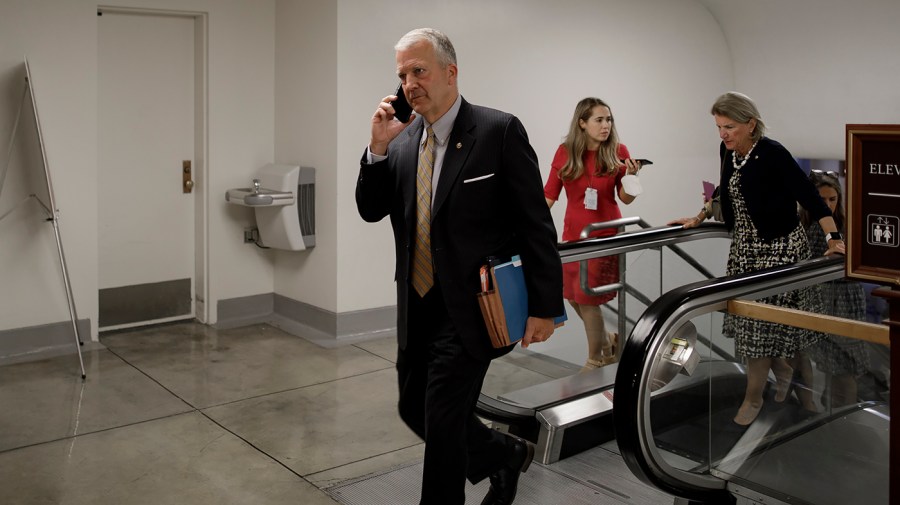 Sen, Dan Sullivan (R-Alaska) walking towards the Senate Chamber for a vote regarding the Honoring our PACT Act on Wednesday, June 15, 2022.