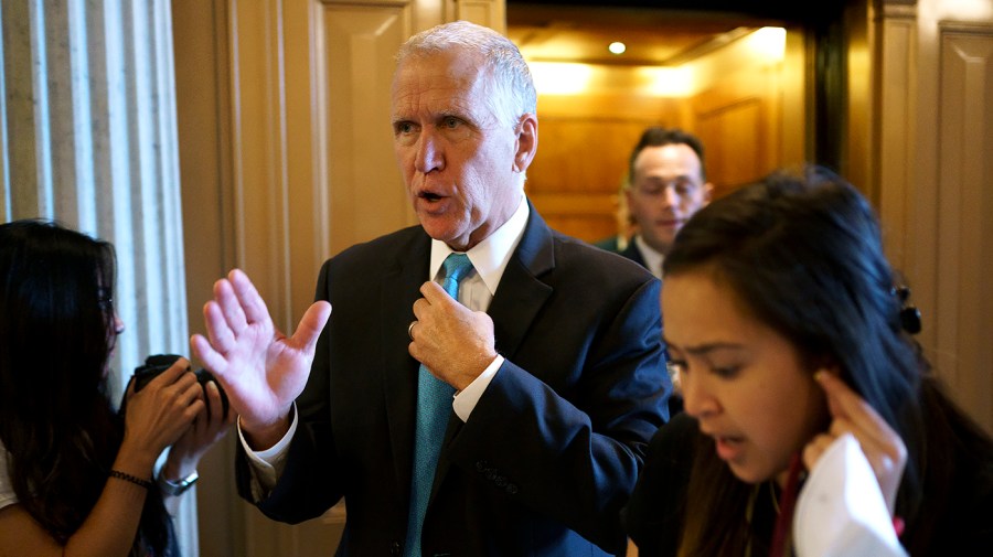 Sen. Thom Tillis (R-N.C.) speaks to a reporter before the weekly Senate Republican policy luncheon on Tuesday, June 14, 2022.