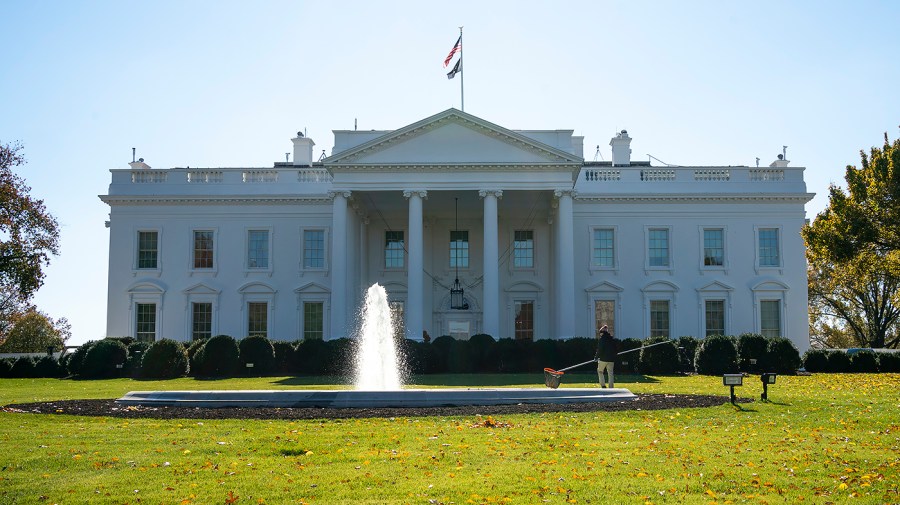 A worker cleans a fountain on the North Lawn of the White House on Friday, November 19, 2021.