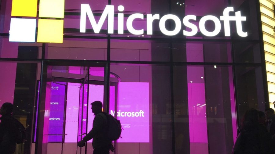 People walk past a Microsoft office in New York.