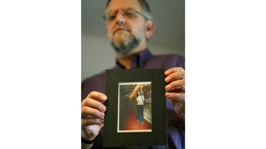 Arnold Roth holds a picture of his 15-year-old daughter, Malki.