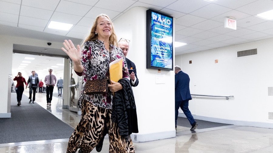 Carole Baskin walks through a hallway