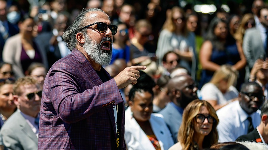 Manuel Oliver, whose son Joaquin was killed in the Parkland mass shooting, interrupts President Biden as he delivers remarks at an event to celebrate the Bipartisan Safer Communities Act on the South Lawn of the White House on July 11, 2022 in Washington, D.C.