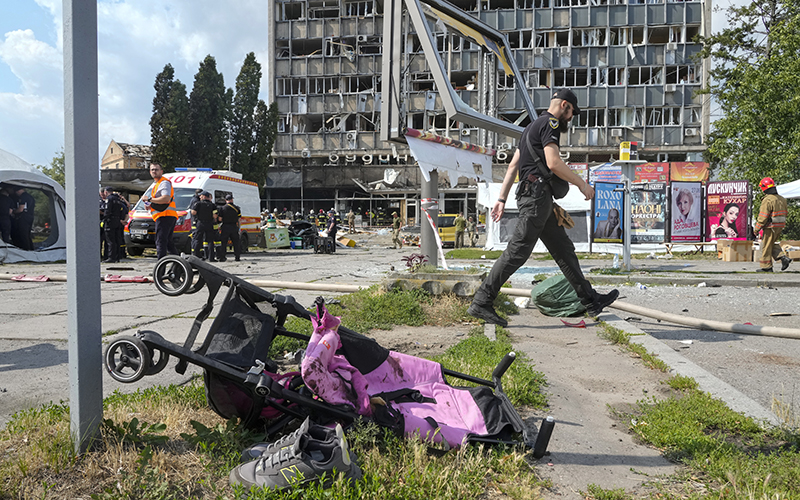 A baby stroller lies by a road after a deadly Russian missile attack