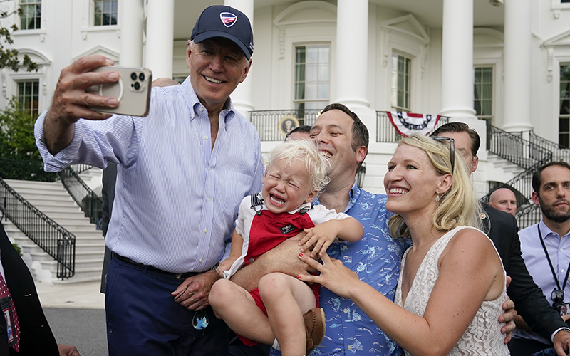 President Biden poses for a photo with guests