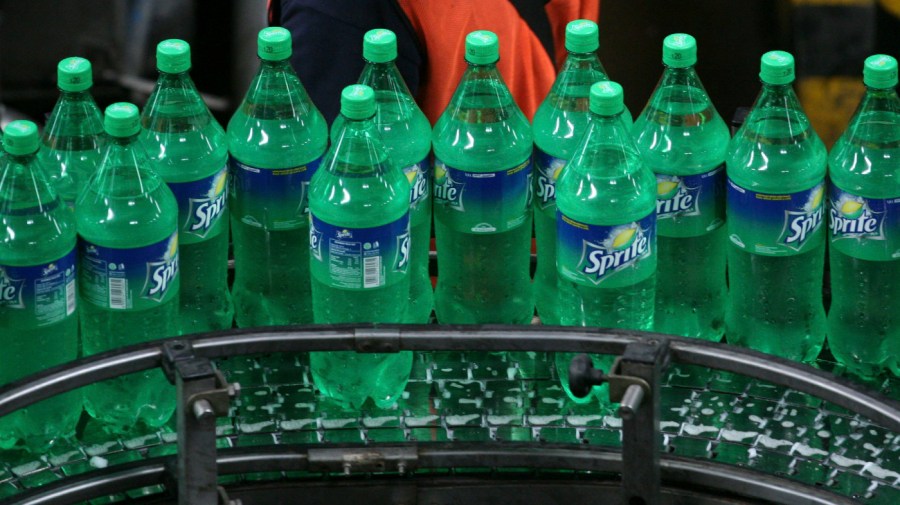 In this Feb. 24, 2011 file photo, a worker inspects bottles of Sprite at a Coca-Cola bottling plant in Cibitung , West Java, Indonesia.